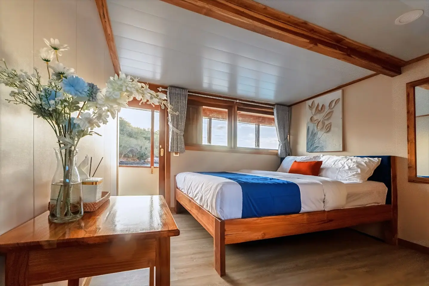 Deluxe Cabin on Ayvara Cruise with queen bed and writing desk