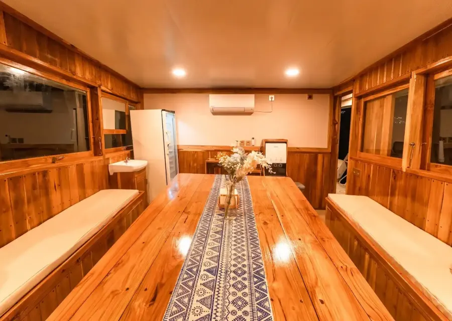 Long dining table in the indoor dining room of Ayvara Cruise
