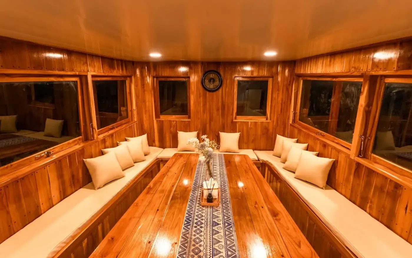 The teak-panelled indoor dining room on Ayvara Cruise