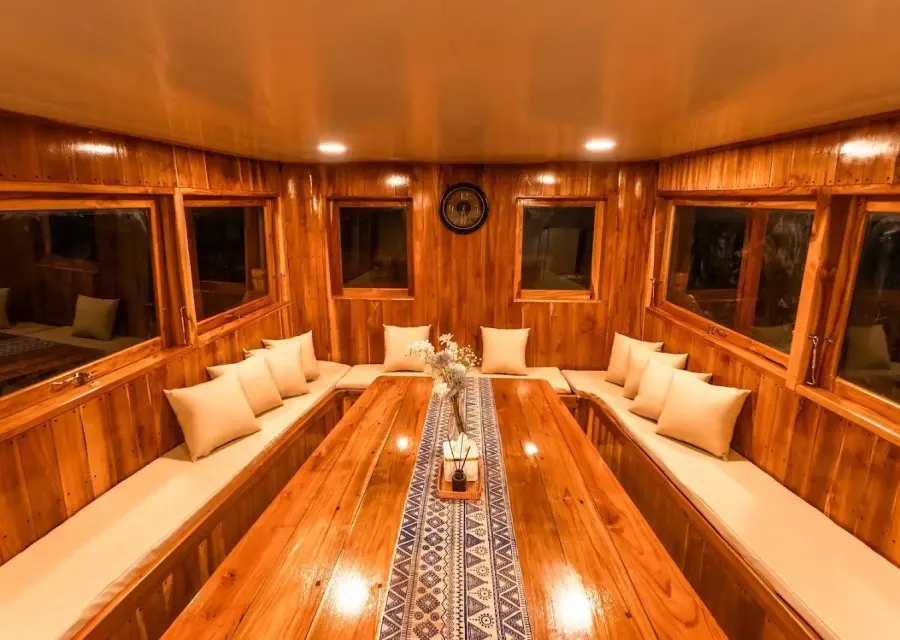 The teak-panelled indoor dining room on Ayvara Cruise