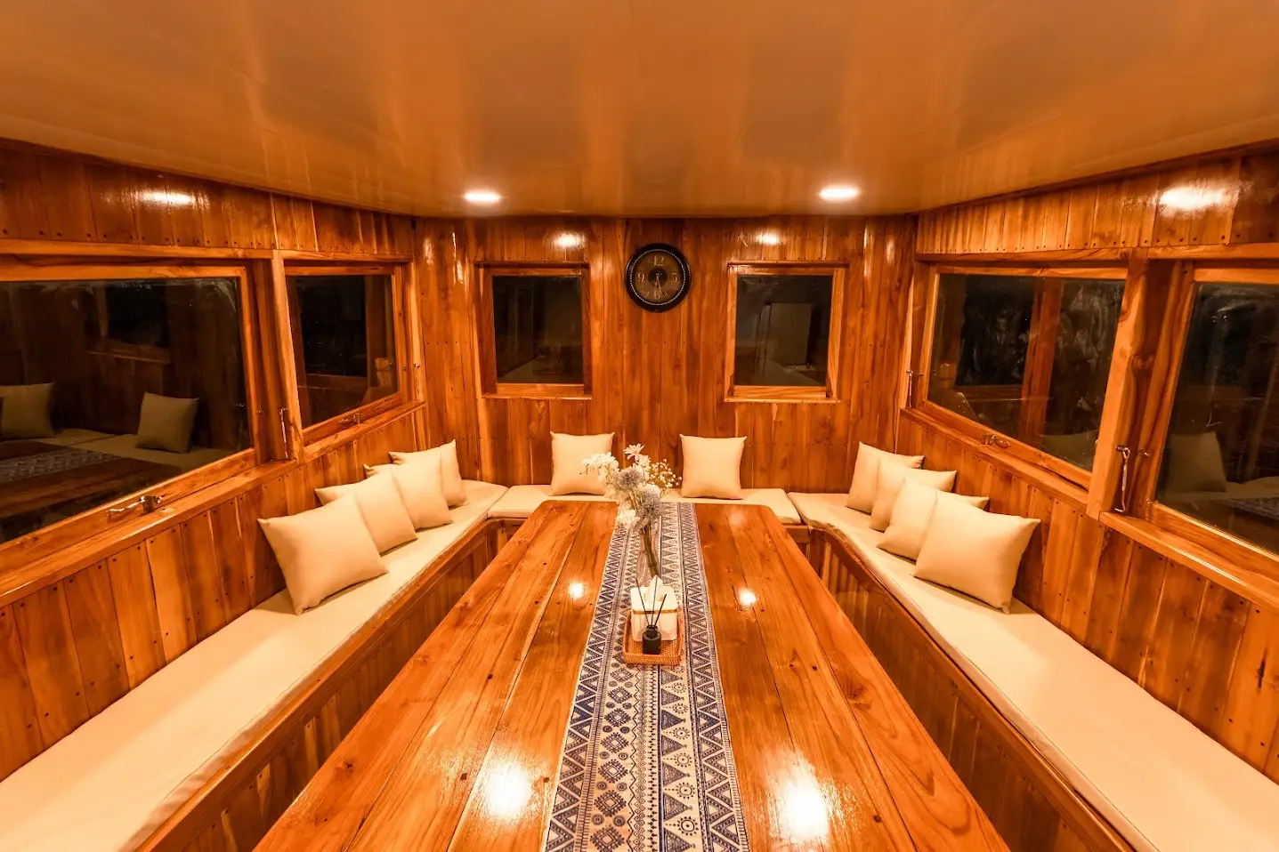The teak-panelled indoor dining room on Ayvara Cruise