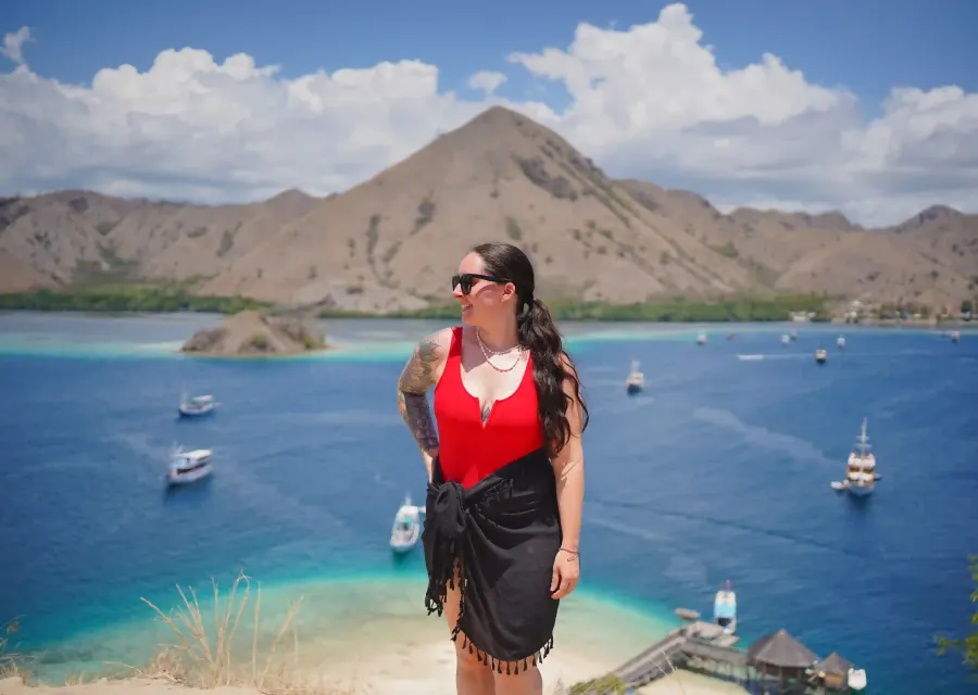 A guest at a hilltop viewpoint above an island anchorage near Labuan Bajo