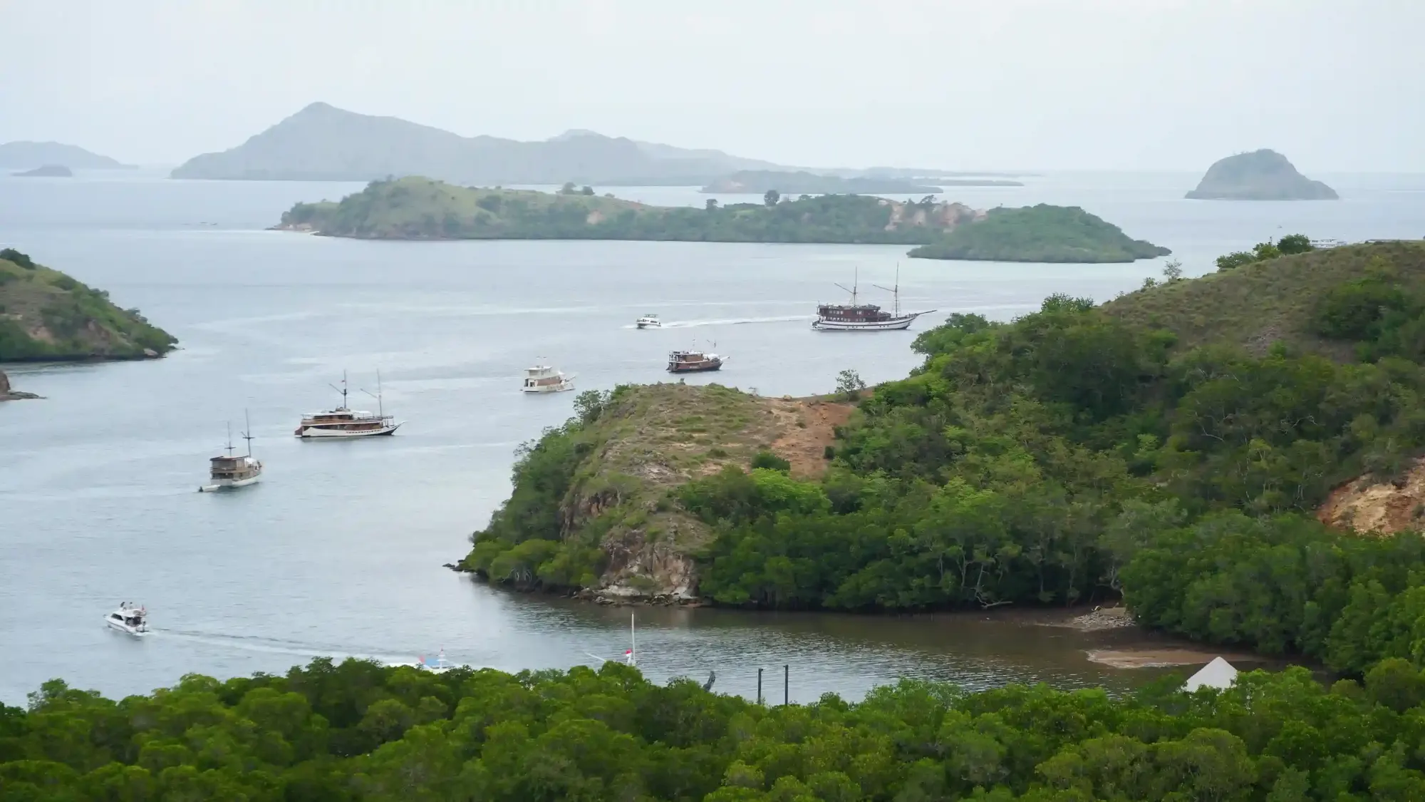 Boats anchored in a bay off Rinca Island